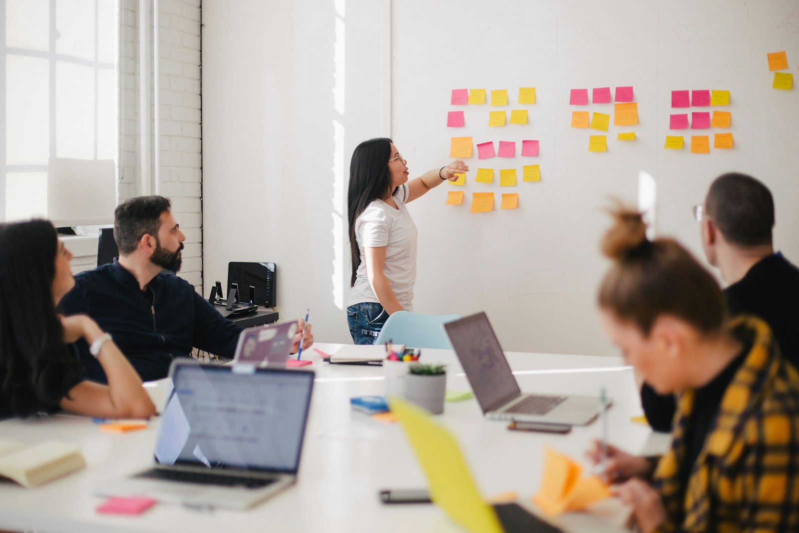 Team organizing ideas with colorful notes on a wall